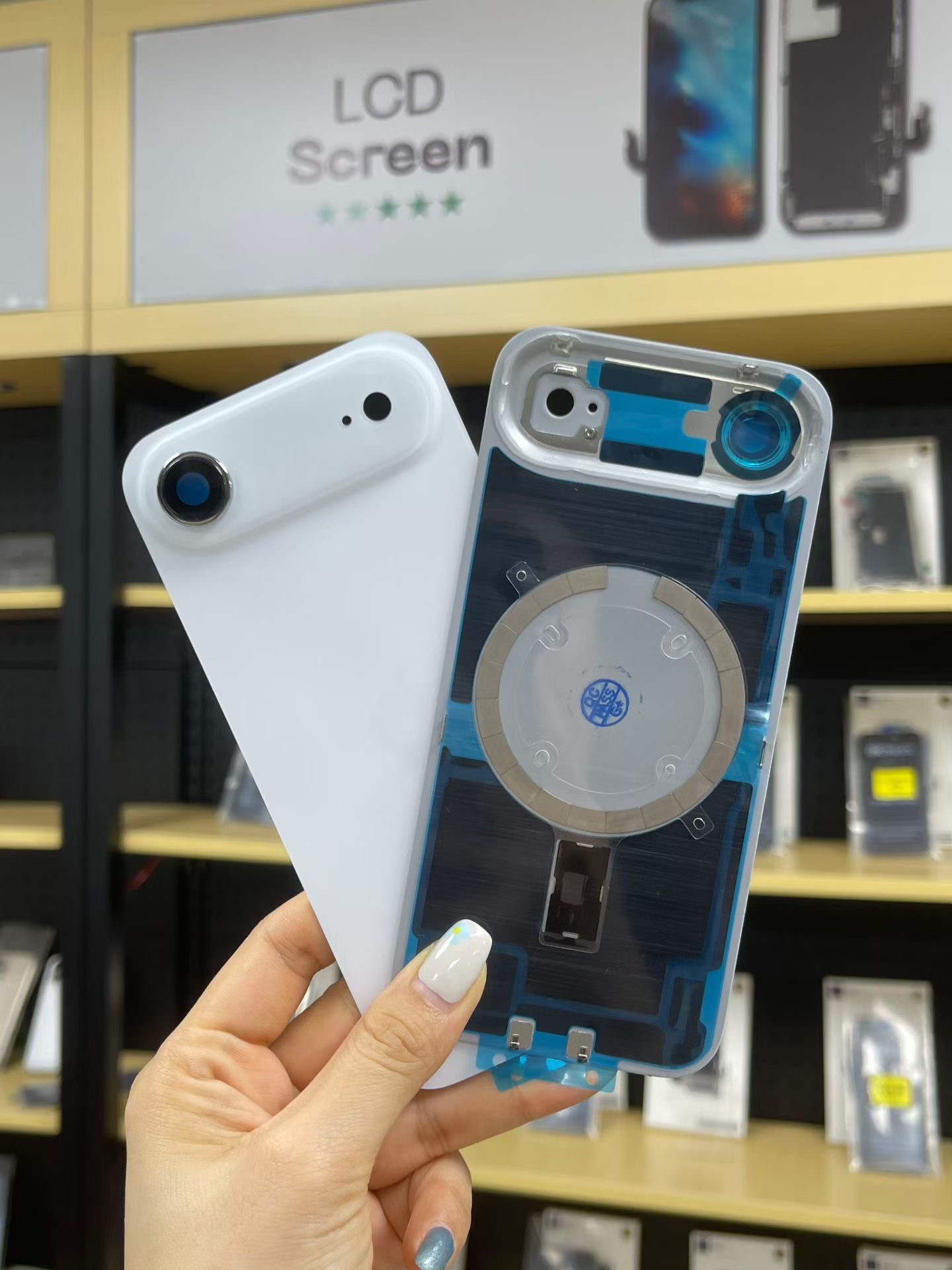 Phone rear housing and wireless charging assembly during repair